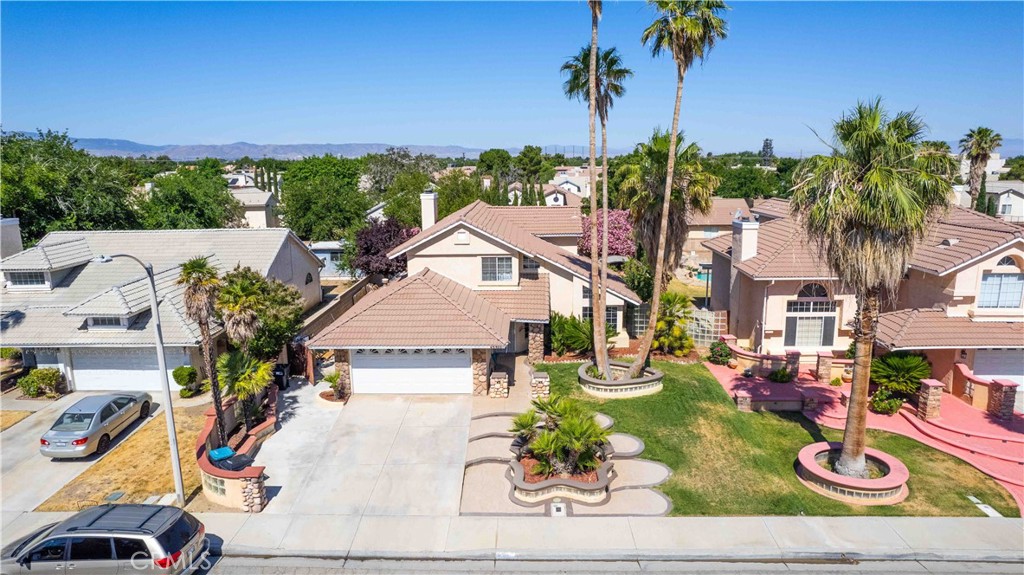 an aerial view of a house with garden space and street view