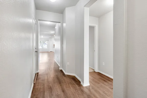 a view of hallway with wooden floor