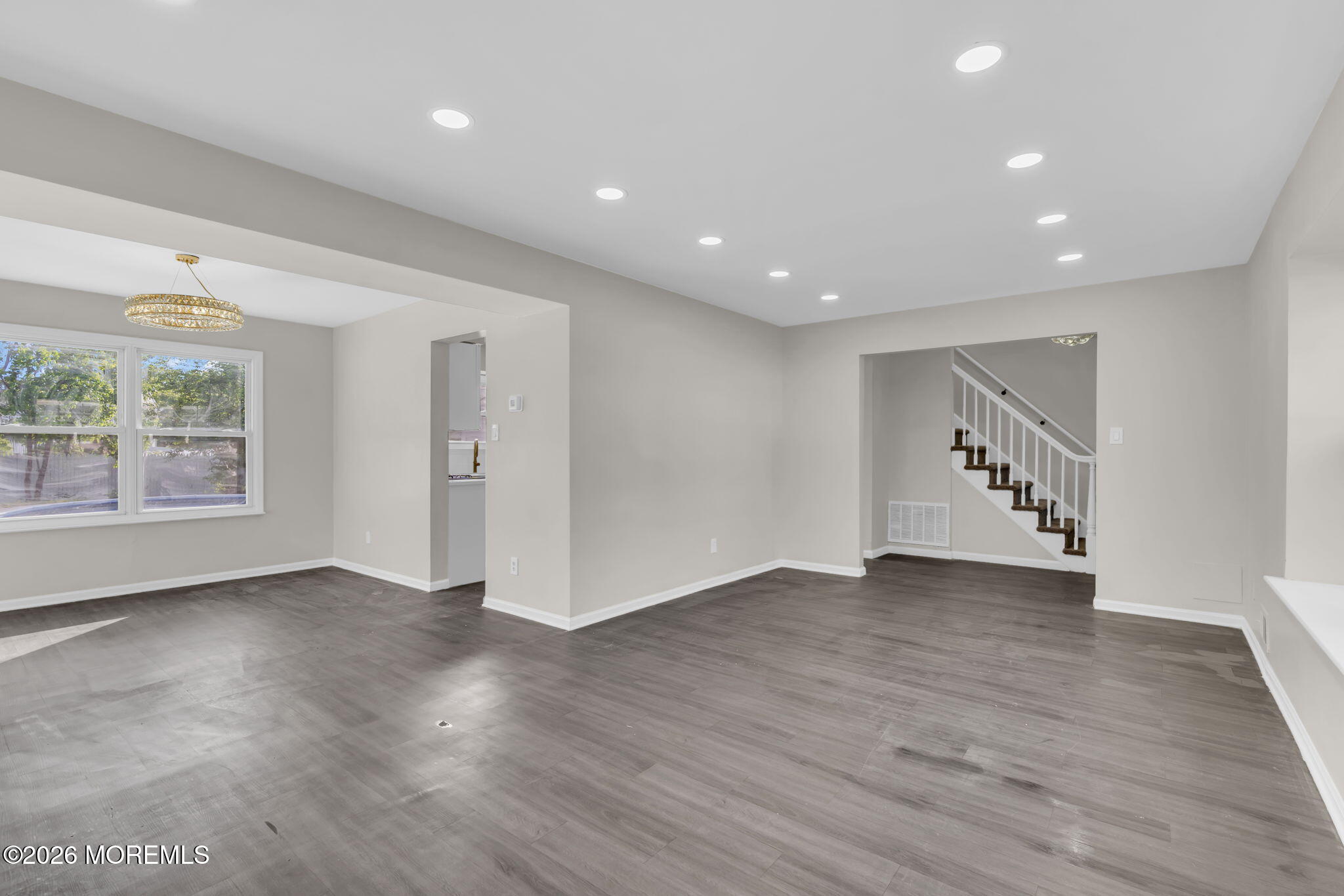 45 Peachstone Road Howell, NJ 07731 - Photo 12 of 54 a view of an empty room with wooden floor and windows