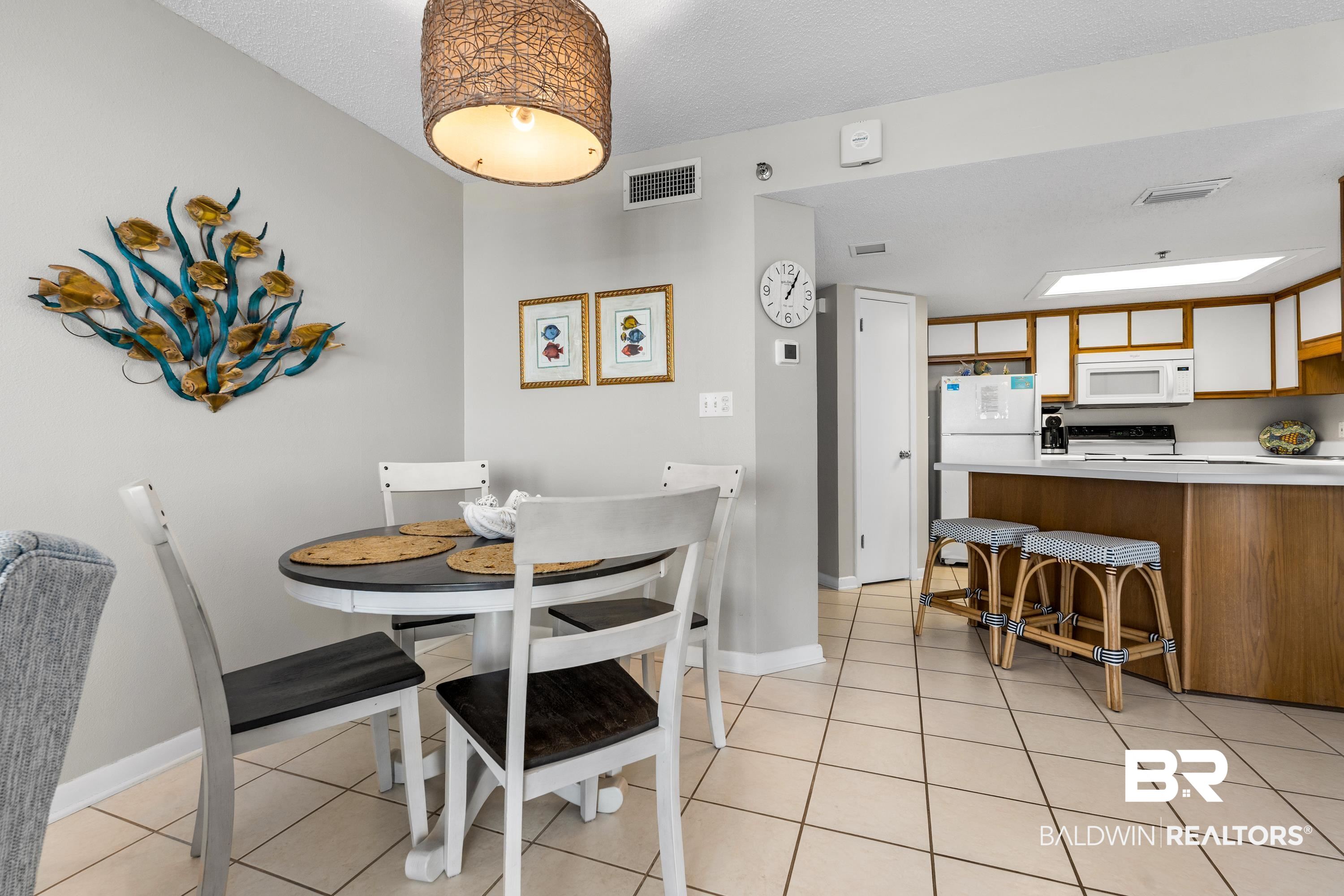 26802 Perdido Beach Boulevard, Unit 406 Orange Beach, AL 36561 - Photo 7 of 37 Dining area featuring light tile patterned flooring and baseboards