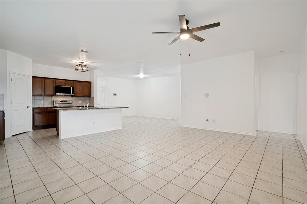 3415 Emerson Road Forney, TX 75126 - Photo 7 of 26 a view of a kitchen with microwave and cabinets
