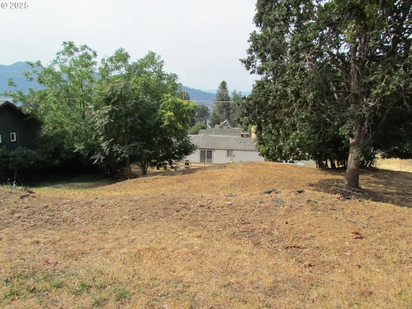 a view of white house with a yard