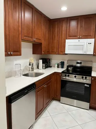 a kitchen with wooden cabinets and a sink