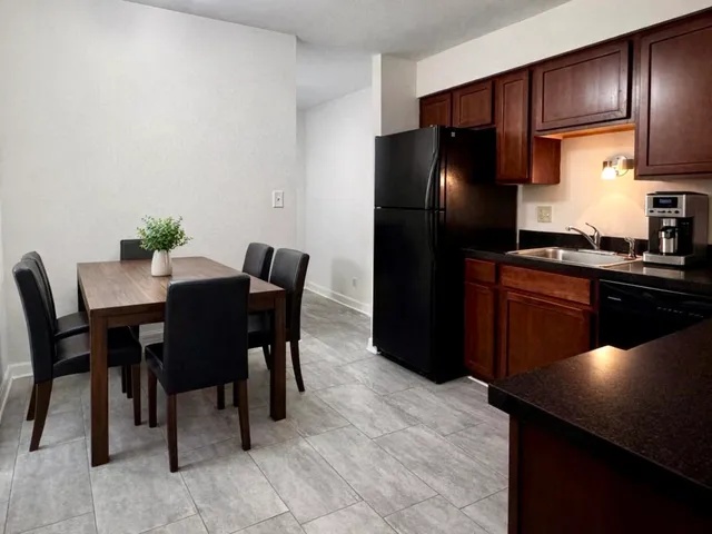 a kitchen with a table and chairs