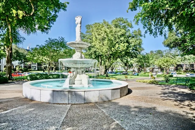 a view of a fountain in the backyard of the house
