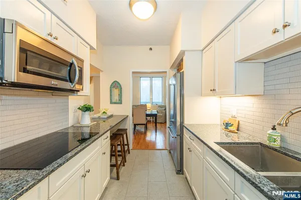 a kitchen with stainless steel appliances granite countertop a sink and stove