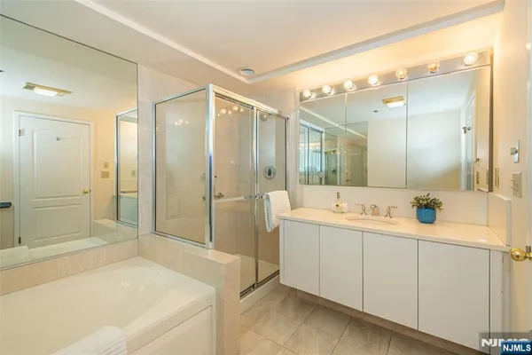 a bathroom with a glass door shower and a sink