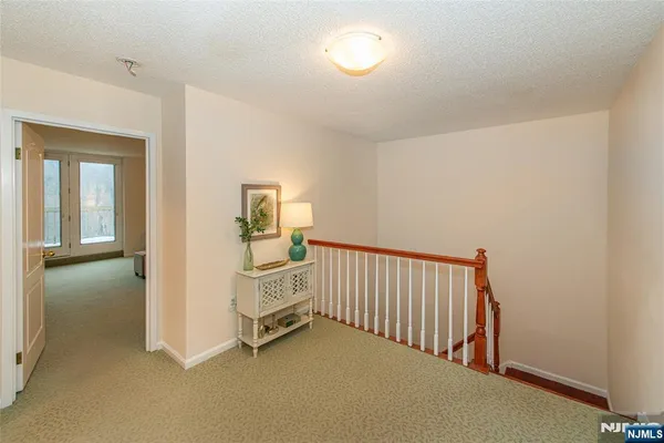 a spacious bedroom with a bed and a lamp