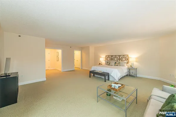 a spacious bedroom with a bed and a couch