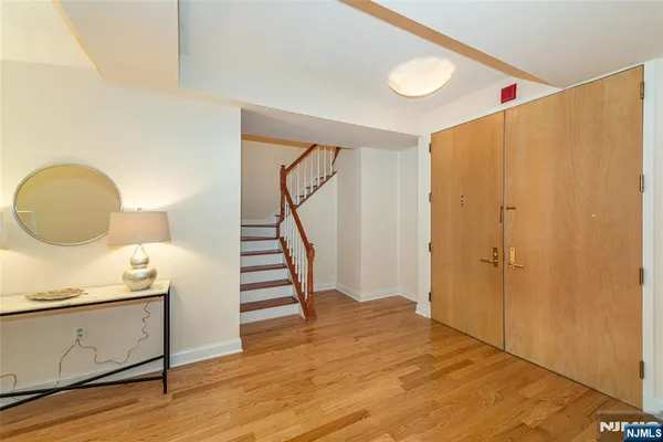 a view of a hallway with wooden floor and staircase