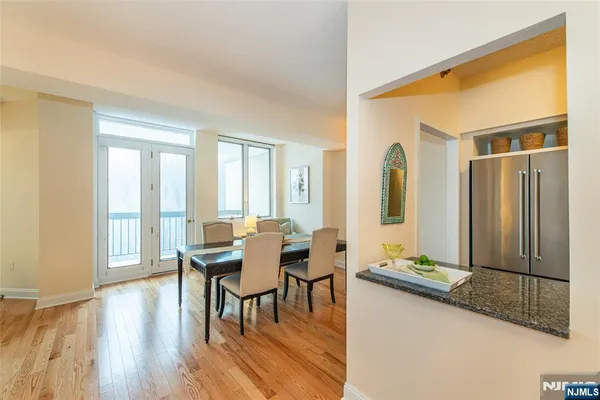 a dining room with furniture and wooden floor