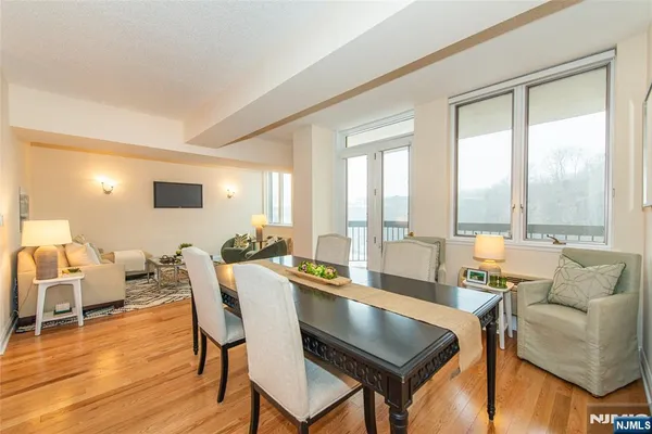 a living room with furniture and floor to ceiling windows