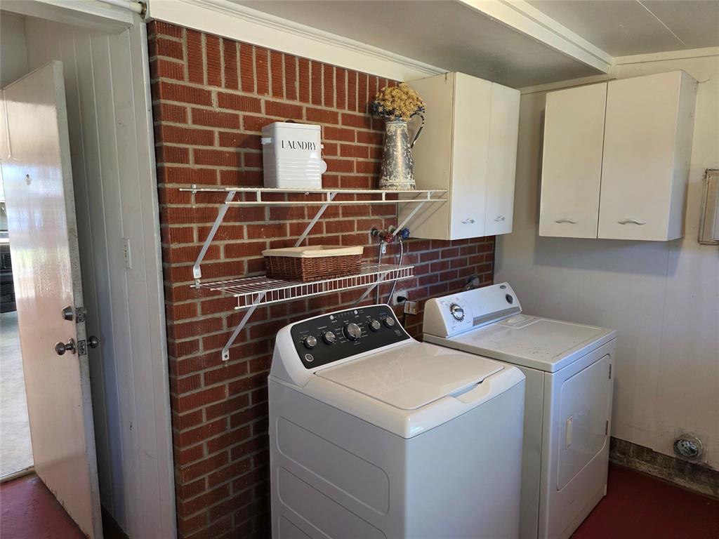 103 North Magnolia Street Plain Dealing, LA 71064 - Photo 13 of 26 Laundry room featuring washer and clothes dryer and cabinet space