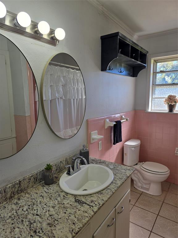 103 North Magnolia Street Plain Dealing, LA 71064 - Photo 20 of 26 Bathroom with curtained shower, vanity, light tile patterned flooring, tile walls, and crown molding