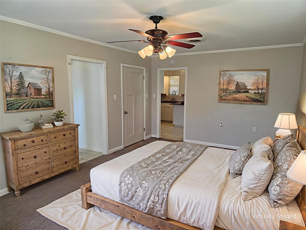 103 North Magnolia Street Plain Dealing, LA 71064 - Photo 21 of 26 Carpeted bedroom with ornamental molding, a closet, and a ceiling fan