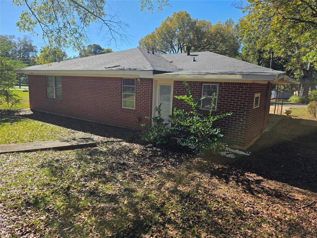 103 North Magnolia Street Plain Dealing, LA 71064 - Photo 24 of 26 Rear view of property featuring brick siding