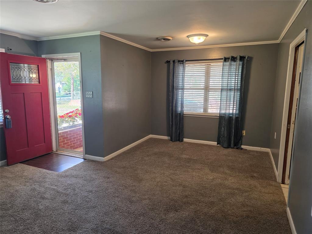 103 North Magnolia Street Plain Dealing, LA 71064 - Photo 6 of 26 Foyer entrance featuring ornamental molding and carpet