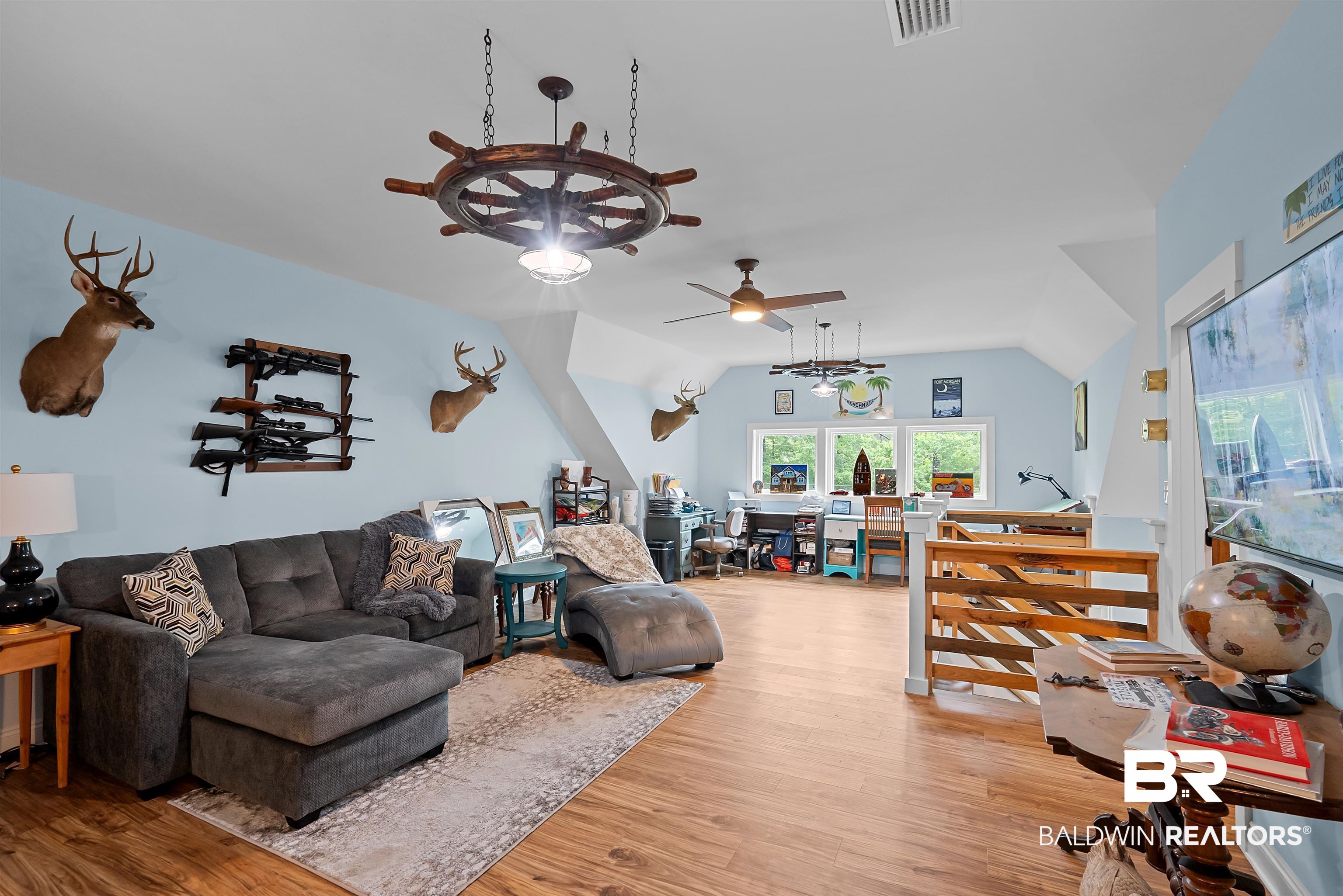7266 Franklin Road Foley, AL 36535 - Photo 44 of 64 Spacious room featuring wood-finish flooring, vaulted ceilings, and light blue walls
