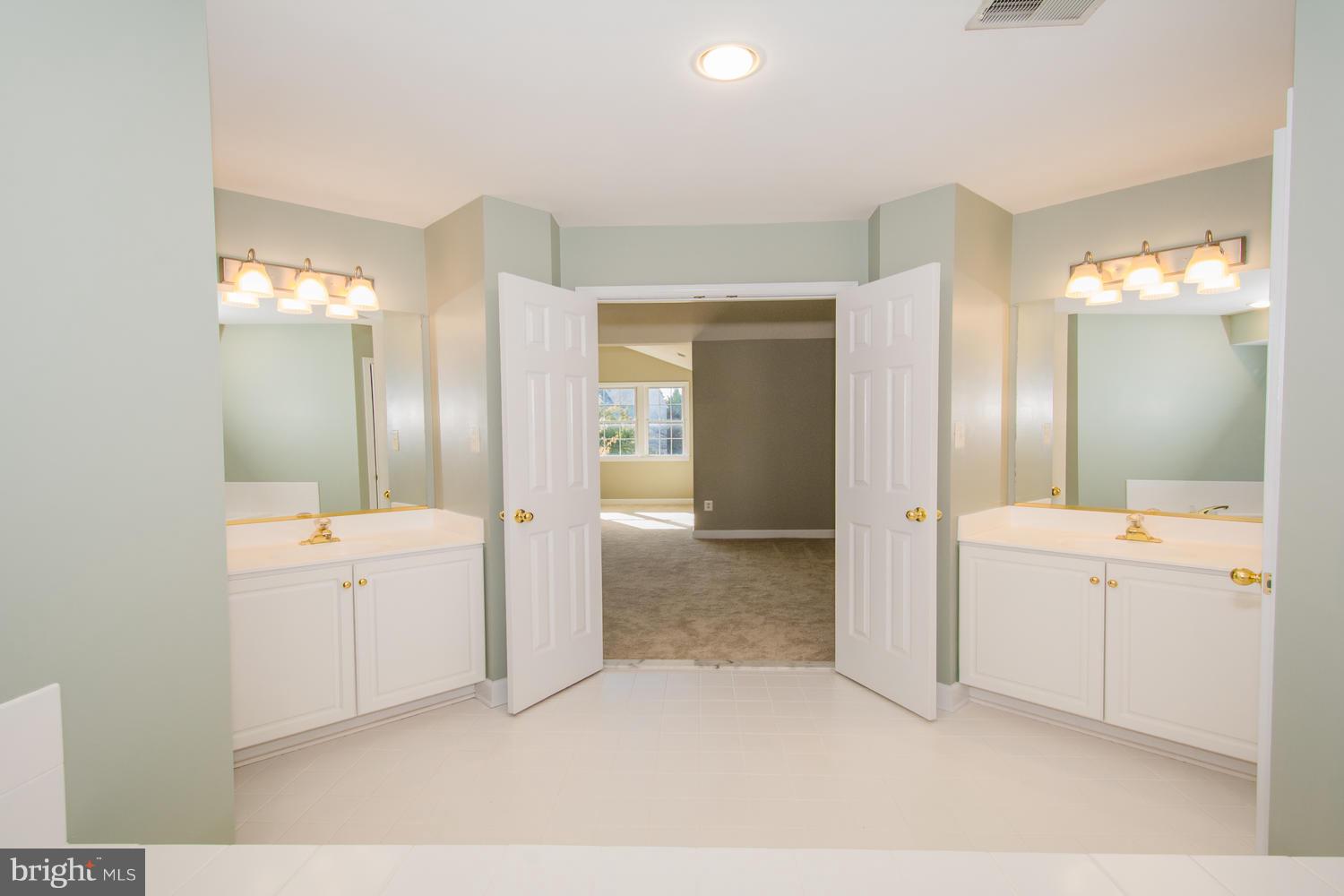 5986 Calvert Way Eldersburg, MD 21784 - Photo 26 of 40 a bathroom with a tub sink and mirror
