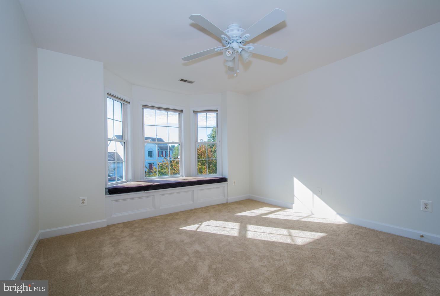 5986 Calvert Way Eldersburg, MD 21784 - Photo 28 of 40 an empty room with windows and fan