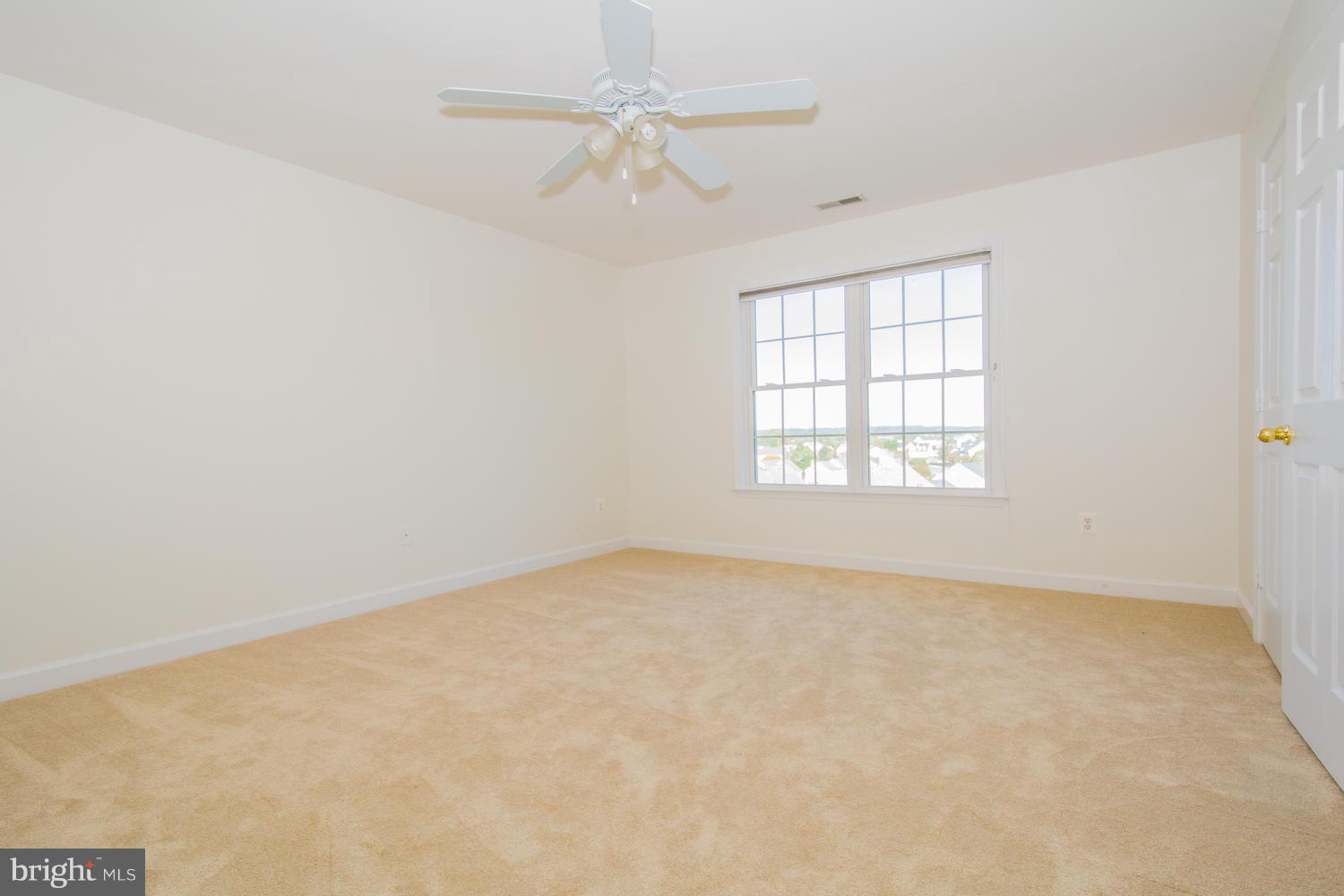5986 Calvert Way Eldersburg, MD 21784 - Photo 29 of 40 an empty room with a window and a fan