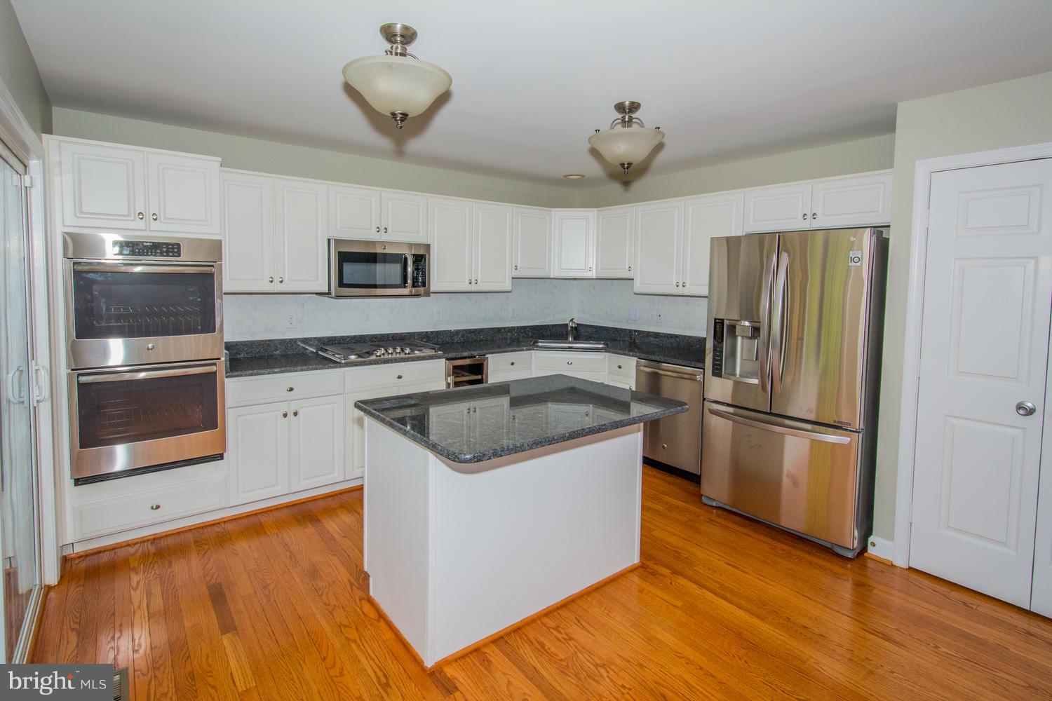 5986 Calvert Way Eldersburg, MD 21784 - Photo 4 of 40 a kitchen with a sink and a refrigerator