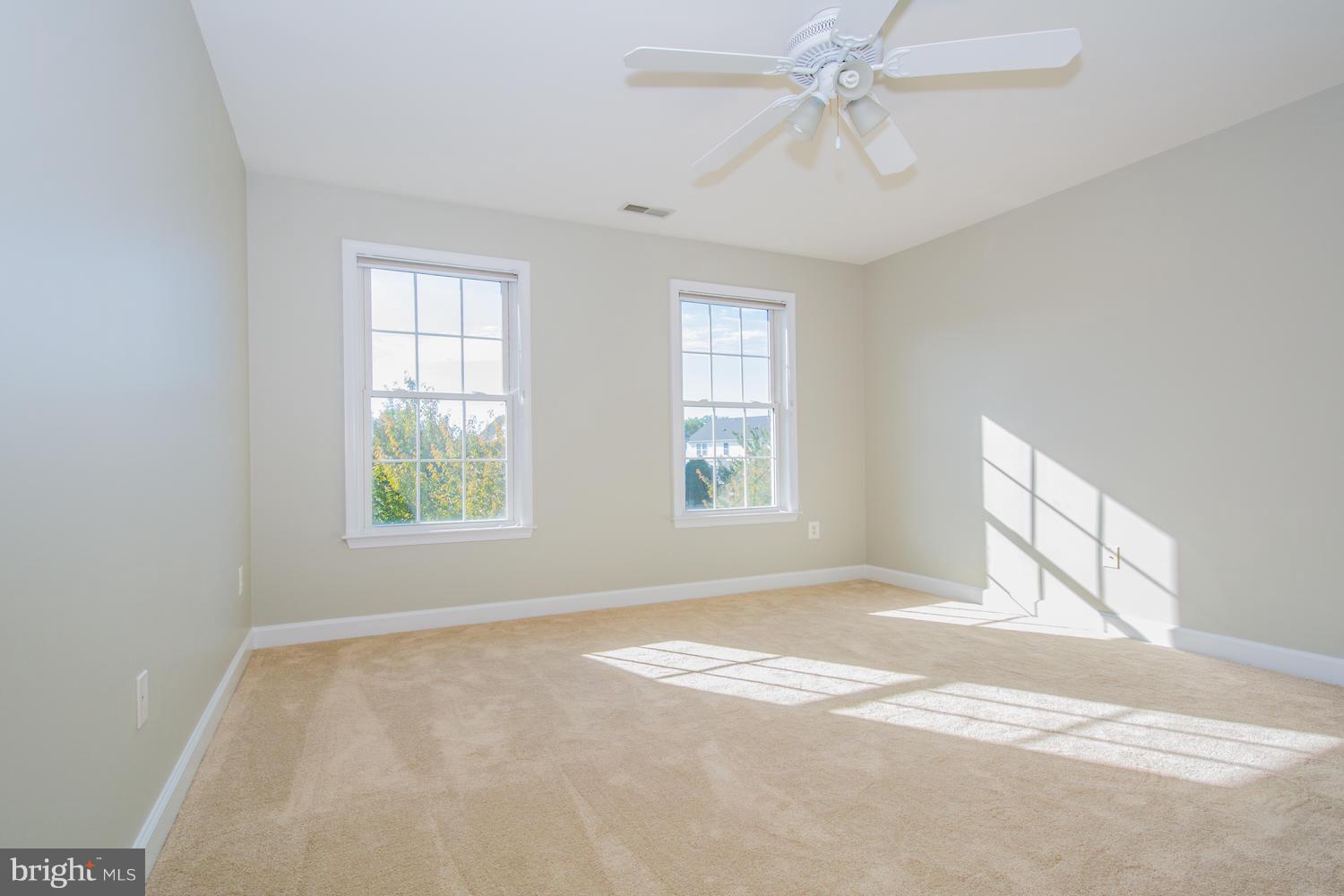 5986 Calvert Way Eldersburg, MD 21784 - Photo 31 of 40 an empty room with windows and fan