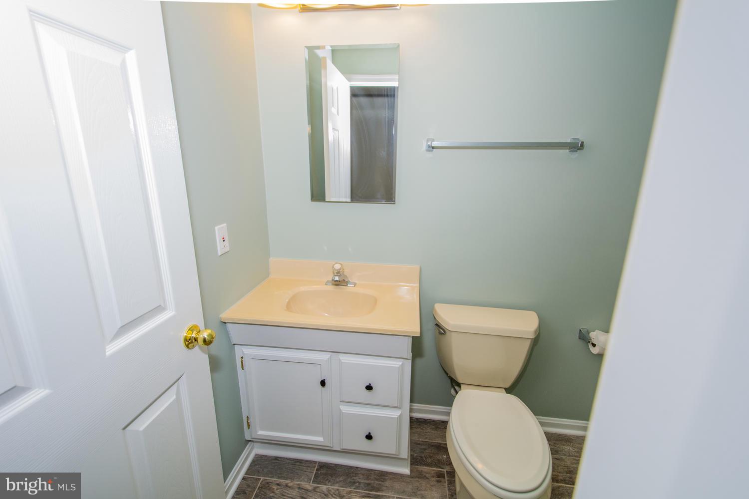 5986 Calvert Way Eldersburg, MD 21784 - Photo 35 of 40 a bathroom with a toilet sink and mirror