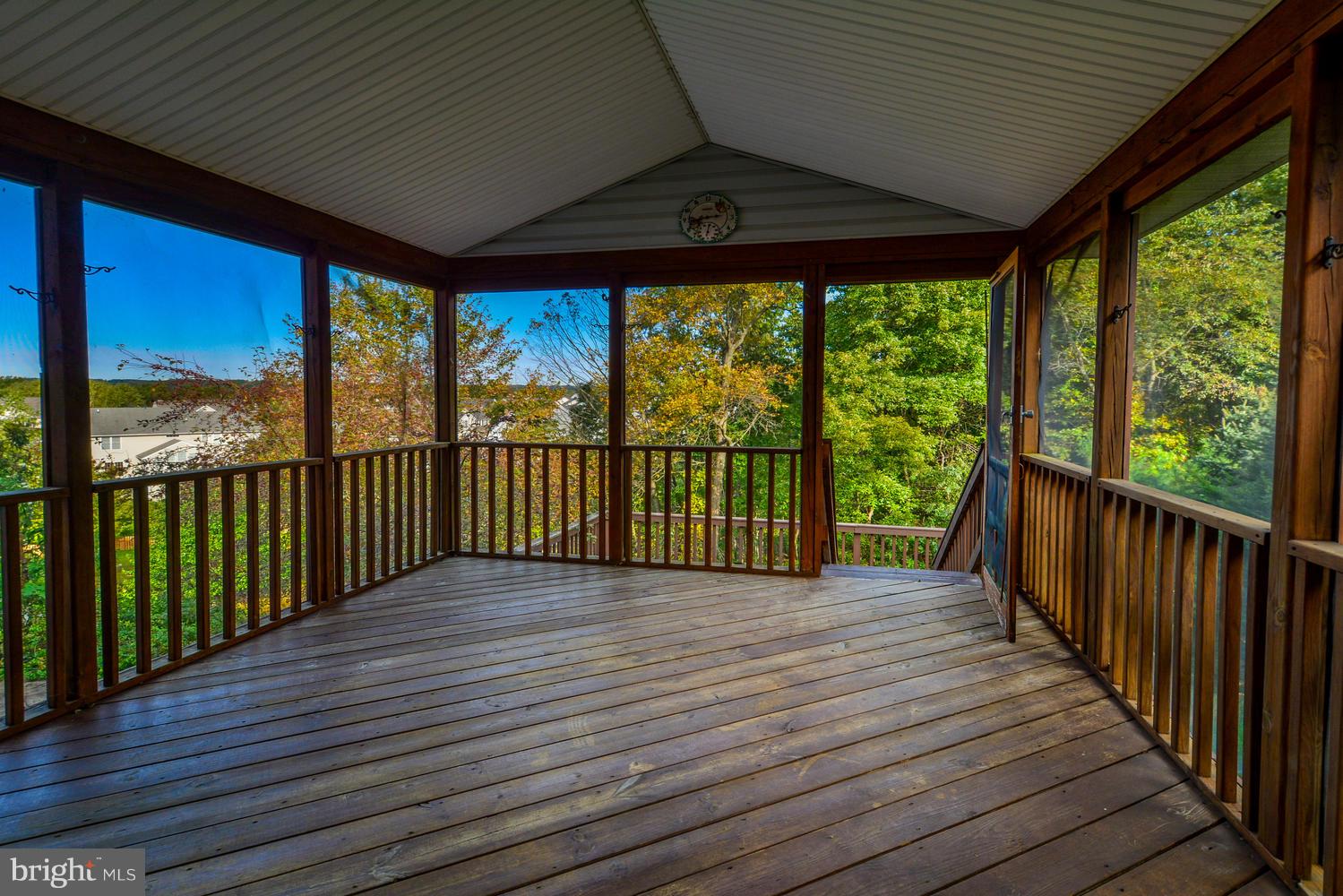 5986 Calvert Way Eldersburg, MD 21784 - Photo 39 of 40 a view of a deck with wooden floor and roof with a floor to ceiling window