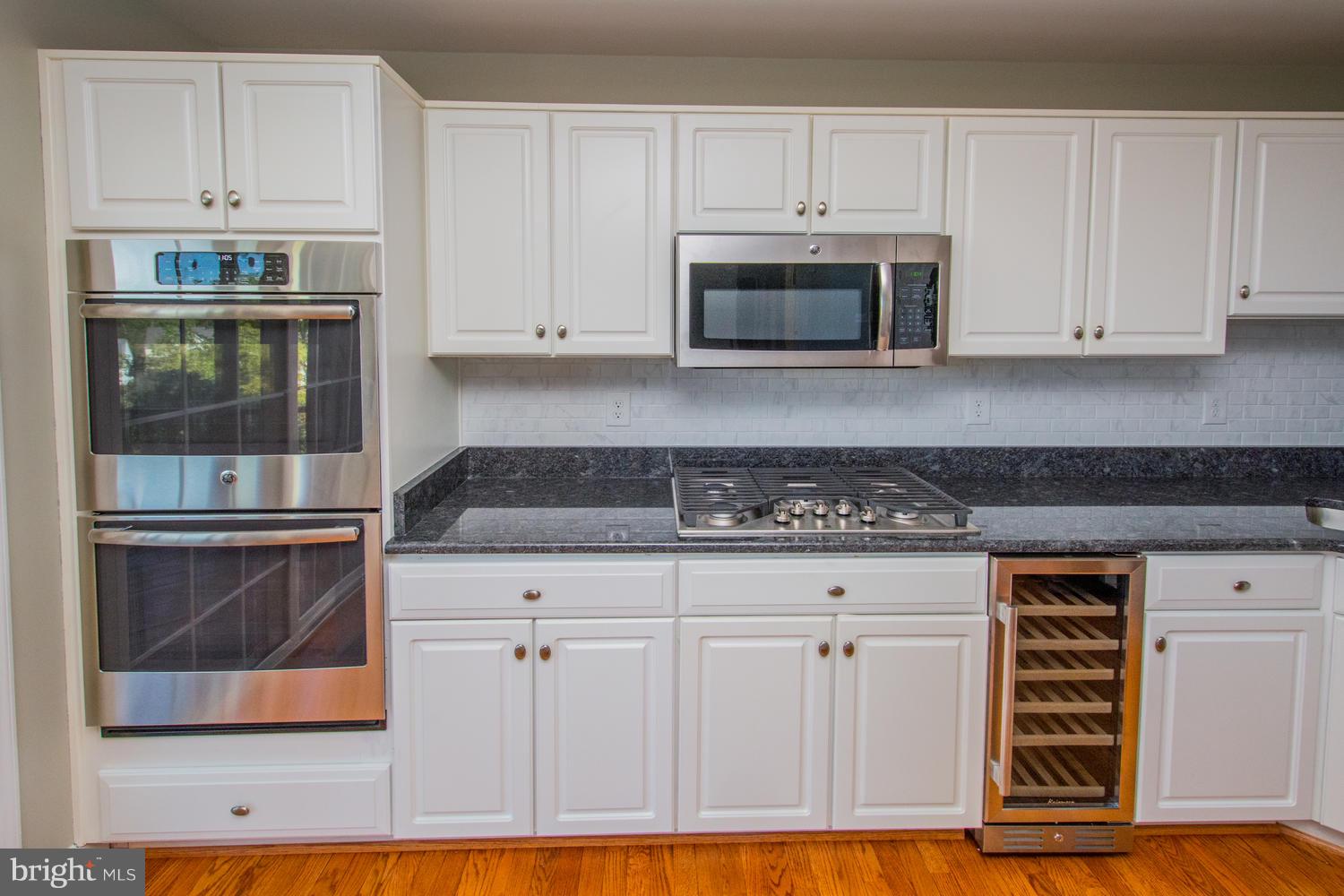 5986 Calvert Way Eldersburg, MD 21784 - Photo 6 of 40 a kitchen with white cabinets and appliances