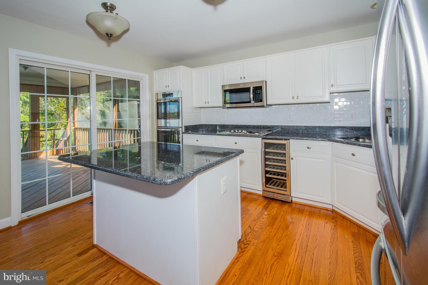 5986 Calvert Way Eldersburg, MD 21784 - Photo 7 of 40 a kitchen with stainless steel appliances granite countertop a sink and a granite counter tops