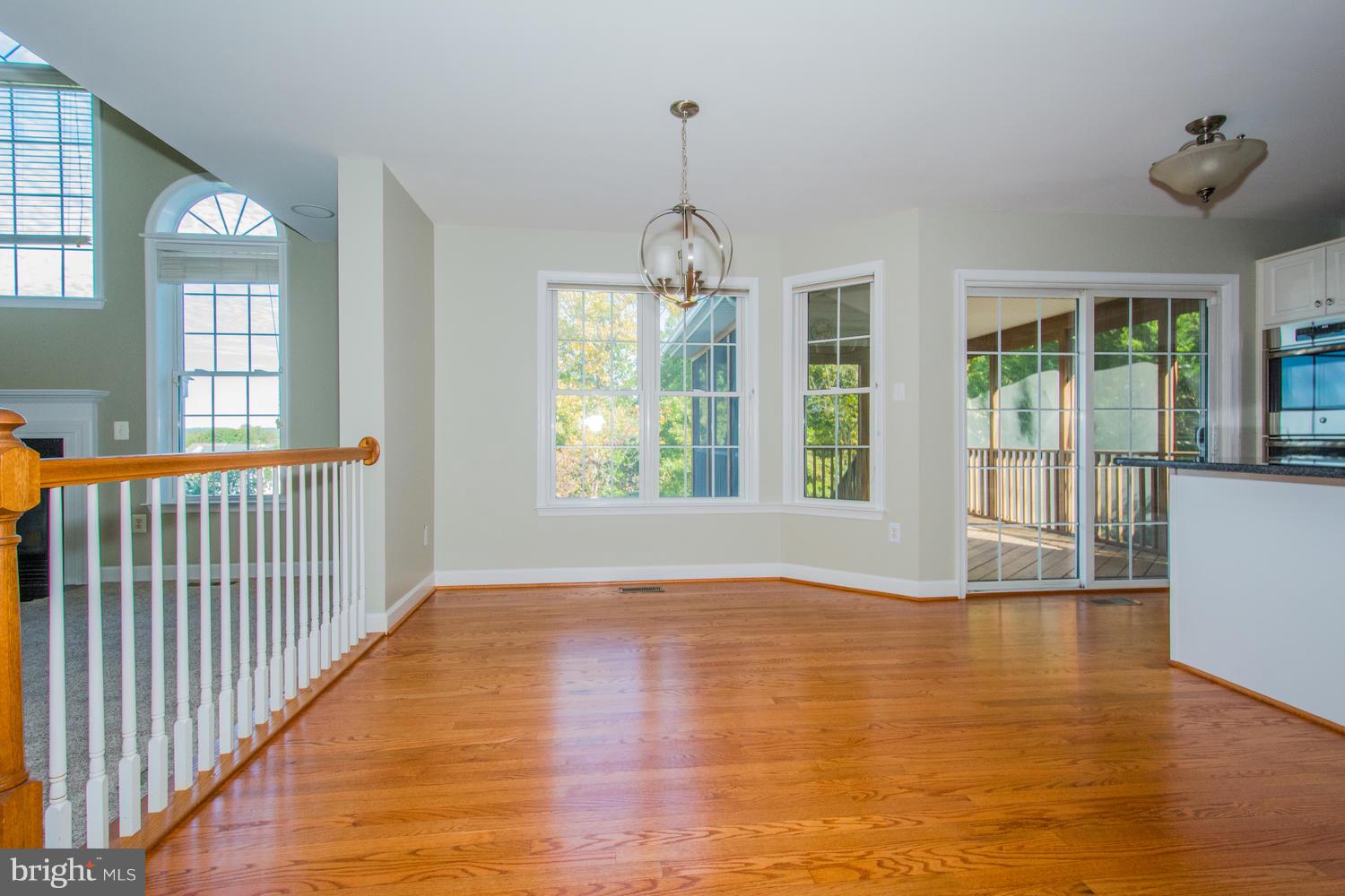 5986 Calvert Way Eldersburg, MD 21784 - Photo 9 of 40 a view of empty room with wooden floor and fan