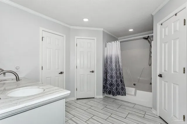 a bathroom with a shower and a sink