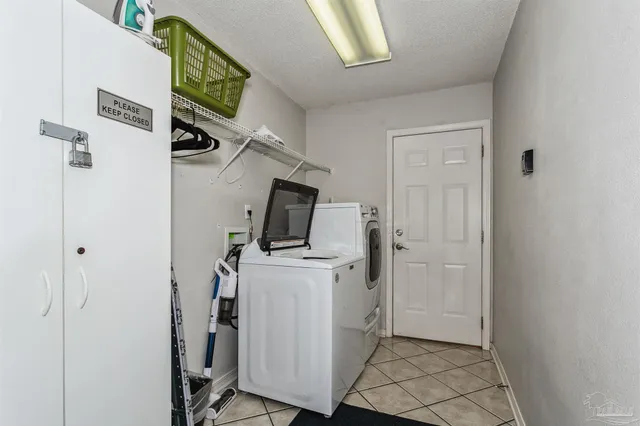 a view of a storage & utility room with washing machine
