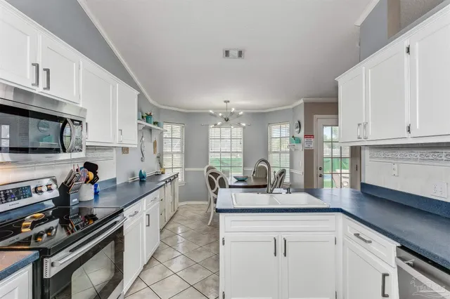 a kitchen with stainless steel appliances a sink stove and cabinets