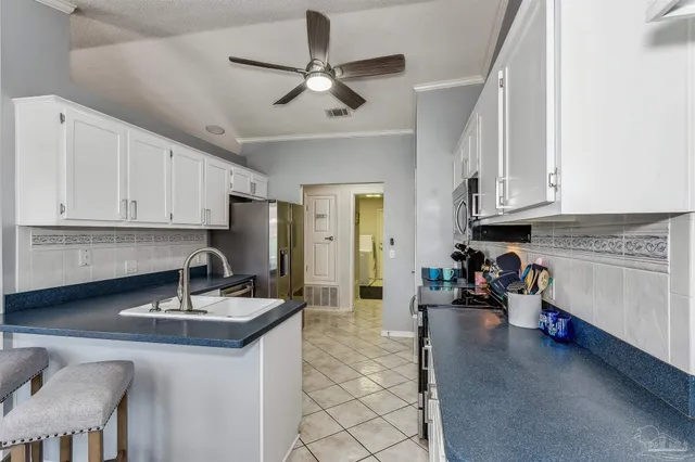 a kitchen with a sink cabinets and window
