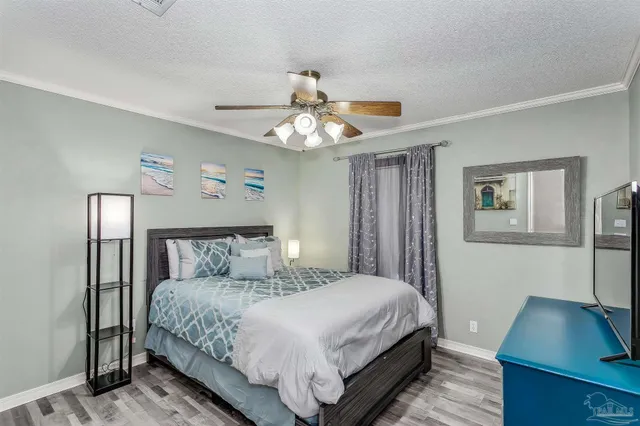 a bedroom with a large bed and a desk