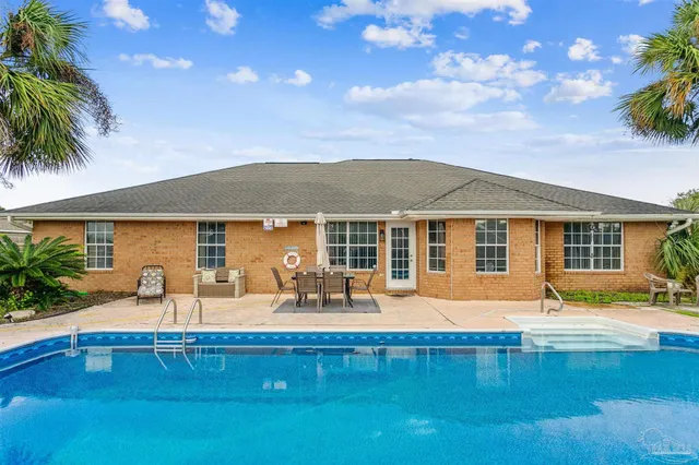 a front view of house with yard and outdoor seating