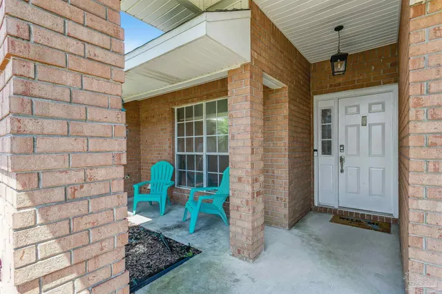 a front view of a house with outdoor seating