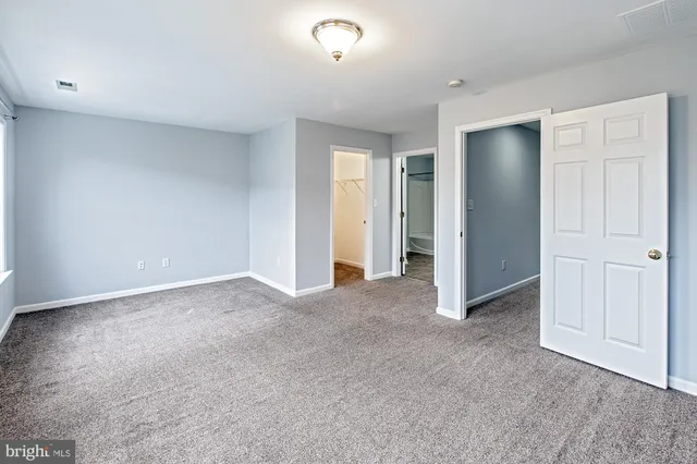 a view of an empty room and closet area