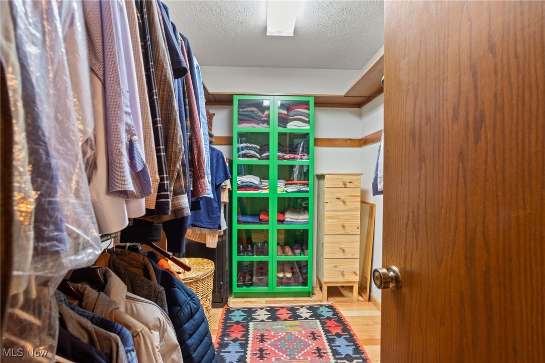 4694 Ranchwood Road Akron, OH 44333 - Photo 32 of 44 Walk in closet with wood finished floors