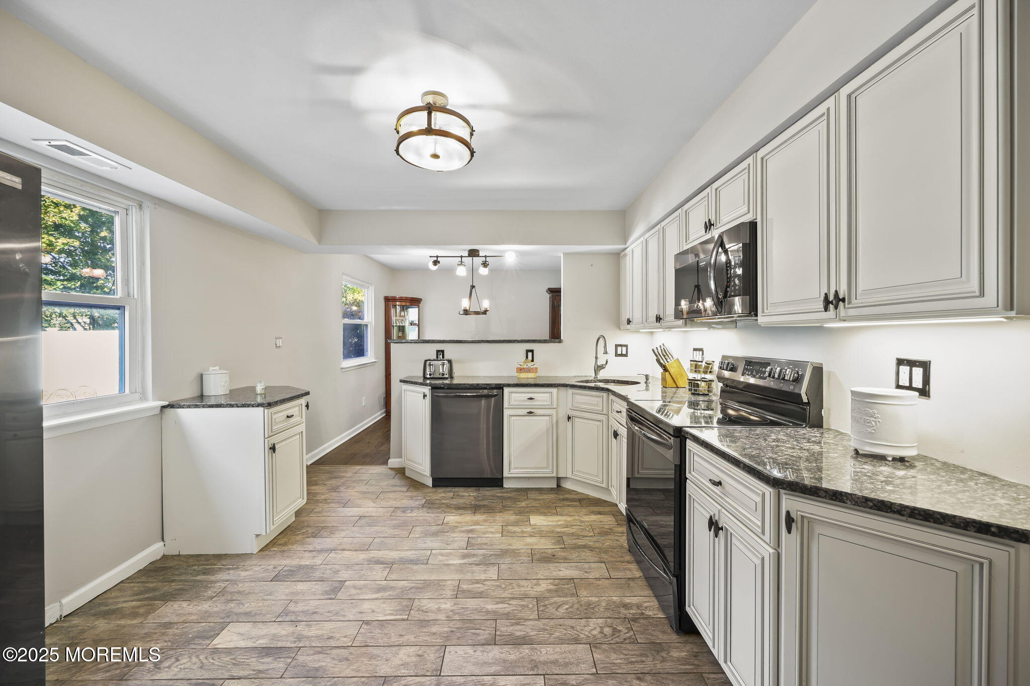 99 Glenarden Drive Howell, NJ 07731 - Photo 16 of 37 a kitchen with granite countertop a sink stainless steel appliances and cabinets