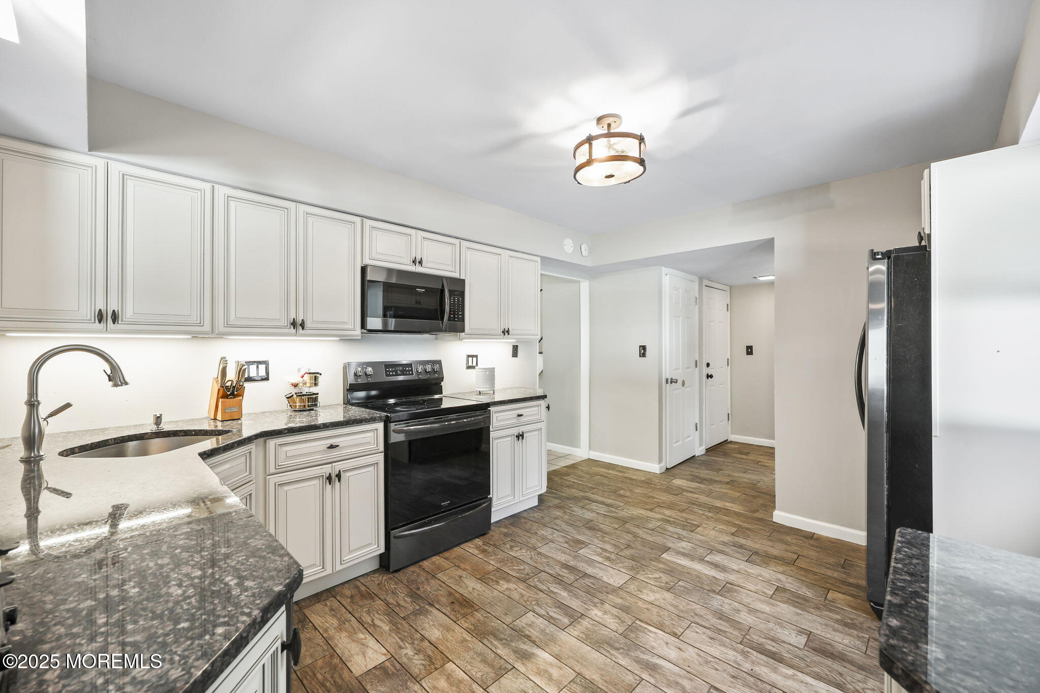 99 Glenarden Drive Howell, NJ 07731 - Photo 17 of 37 a kitchen with stainless steel appliances granite countertop a refrigerator stove microwave and sink