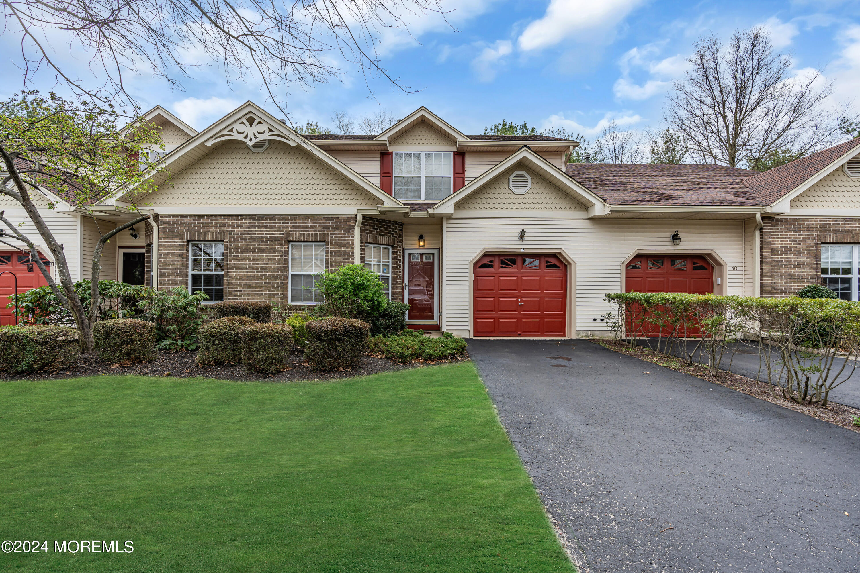 12 Riva Boulevard Brick, NJ 08723 - Photo 1 of 36 a front view of a house with a yard and garage