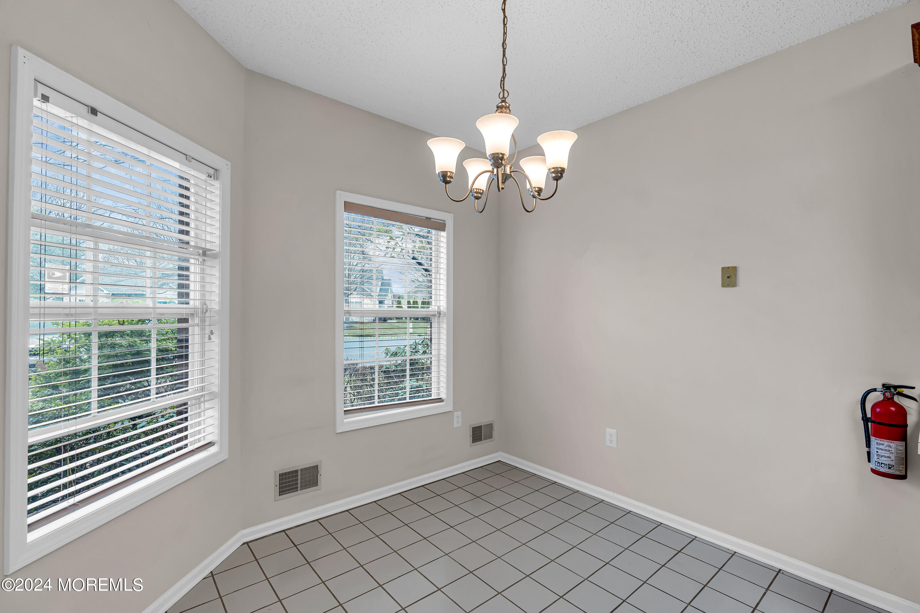 12 Riva Boulevard Brick, NJ 08723 - Photo 11 of 36 a view of a livingroom with a chandelier fan and windows