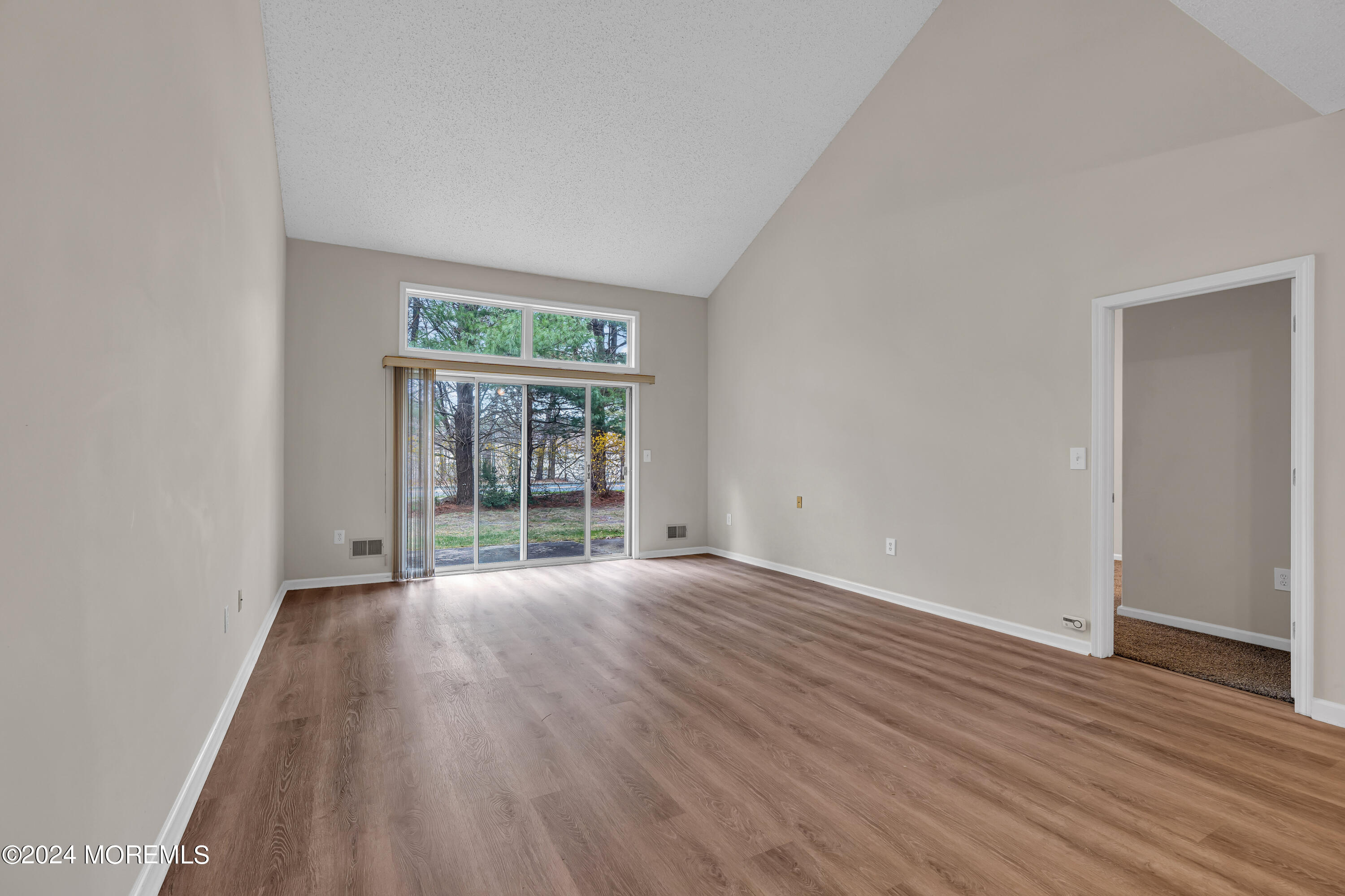 12 Riva Boulevard Brick, NJ 08723 - Photo 14 of 36 a view of an empty room with wooden floor and a window