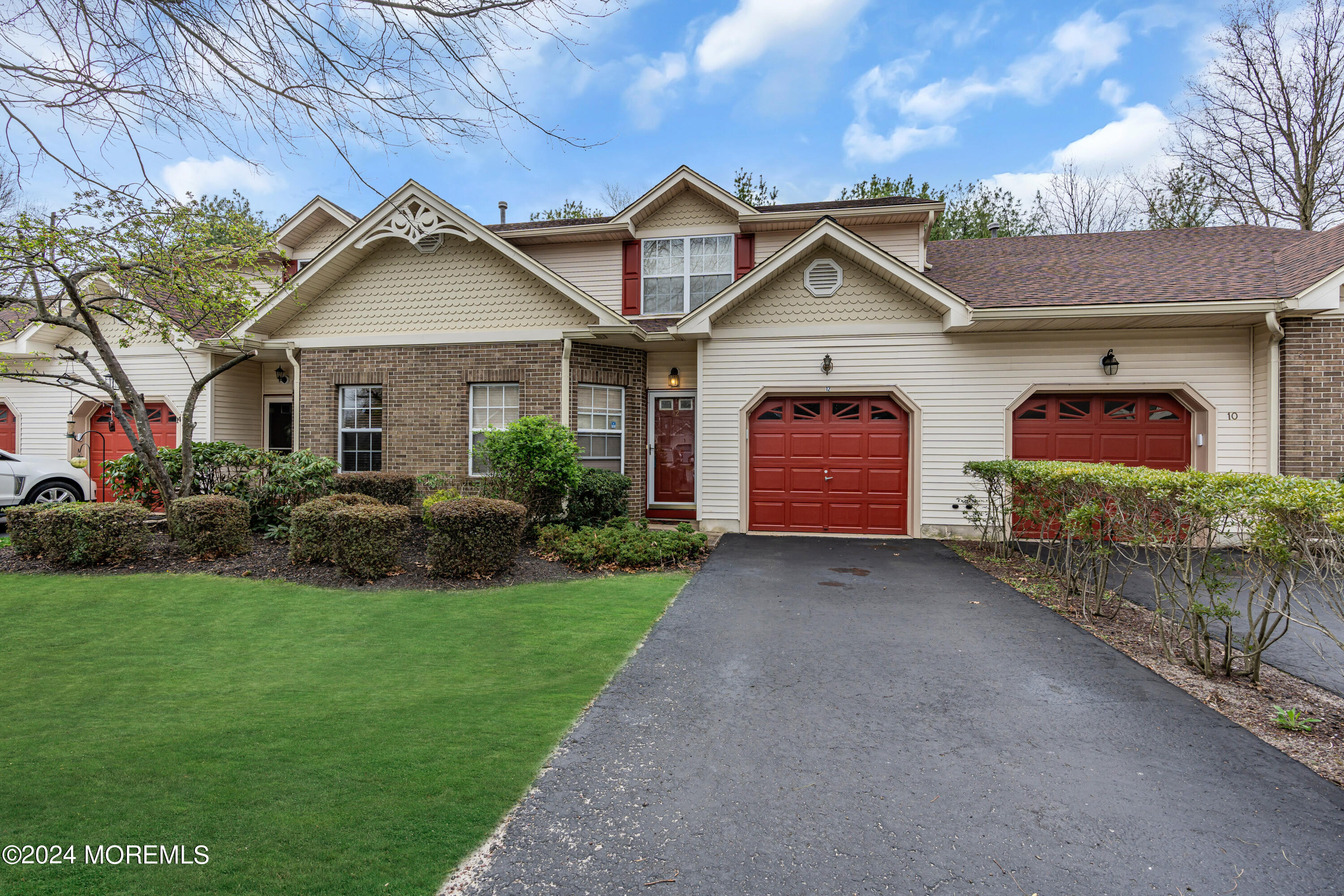 12 Riva Boulevard Brick, NJ 08723 - Photo 2 of 36 a front view of a house with a yard and garage