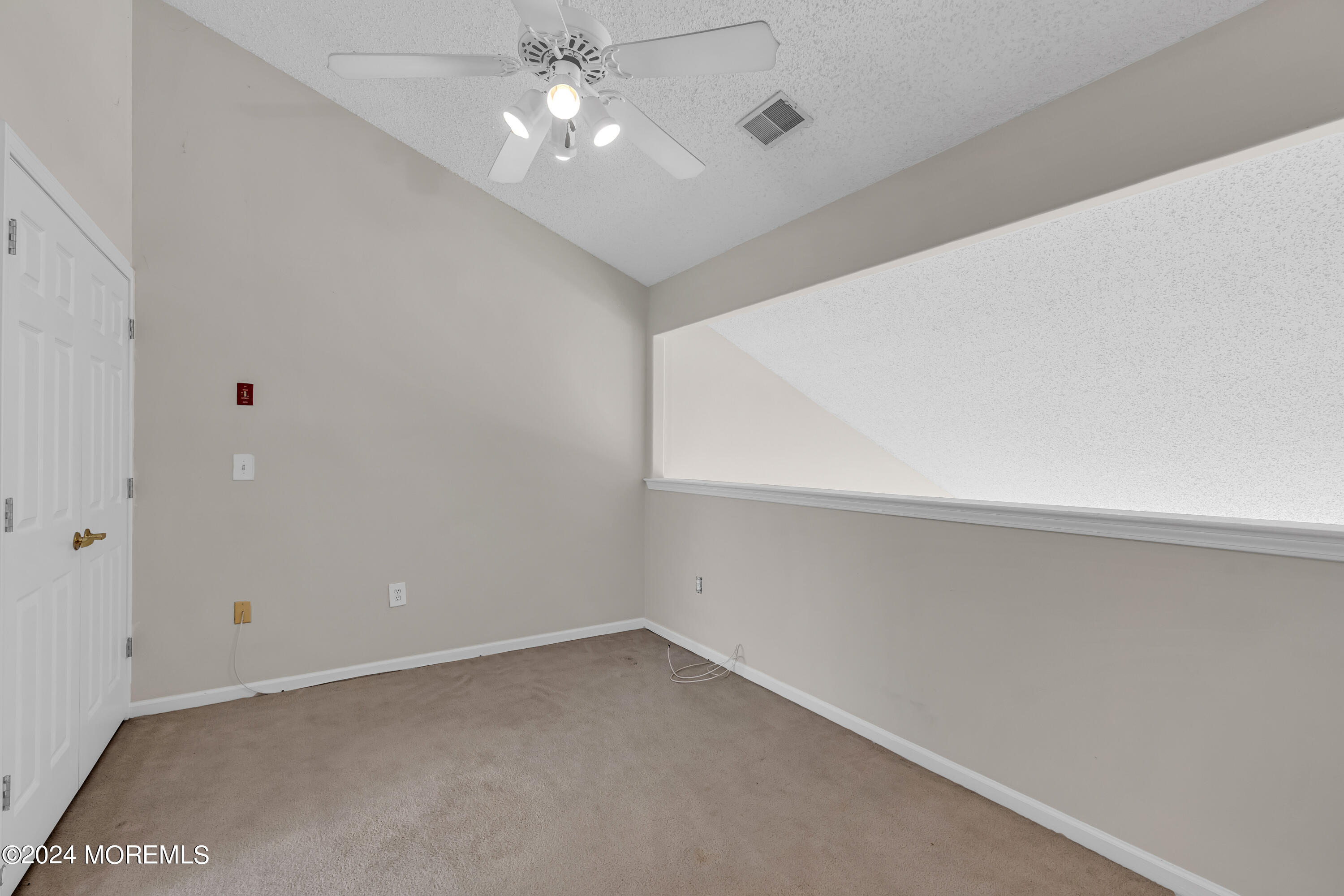 12 Riva Boulevard Brick, NJ 08723 - Photo 23 of 36 an empty room with a ceiling fan and a window