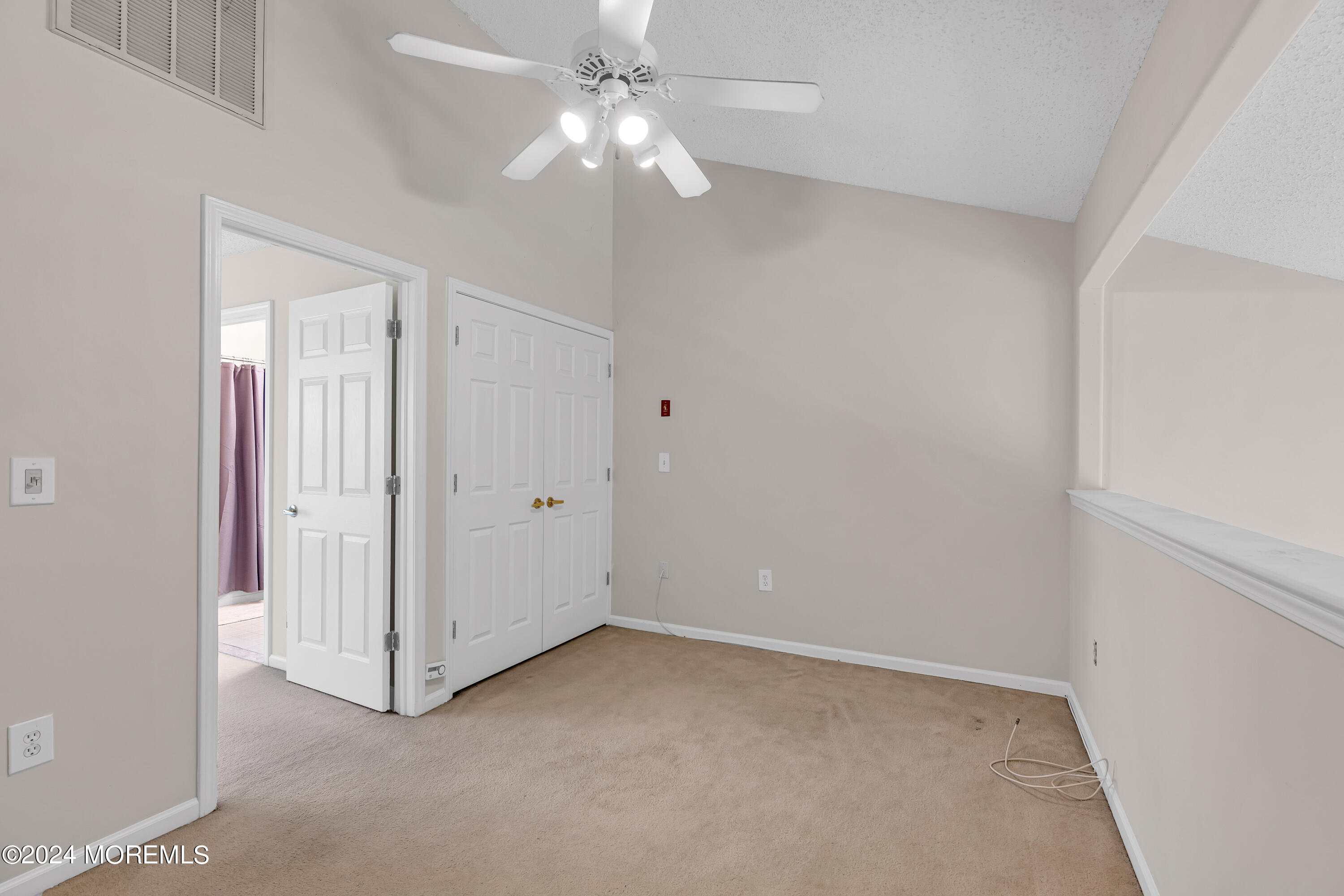12 Riva Boulevard Brick, NJ 08723 - Photo 24 of 36 an empty room with a ceiling fan and a window