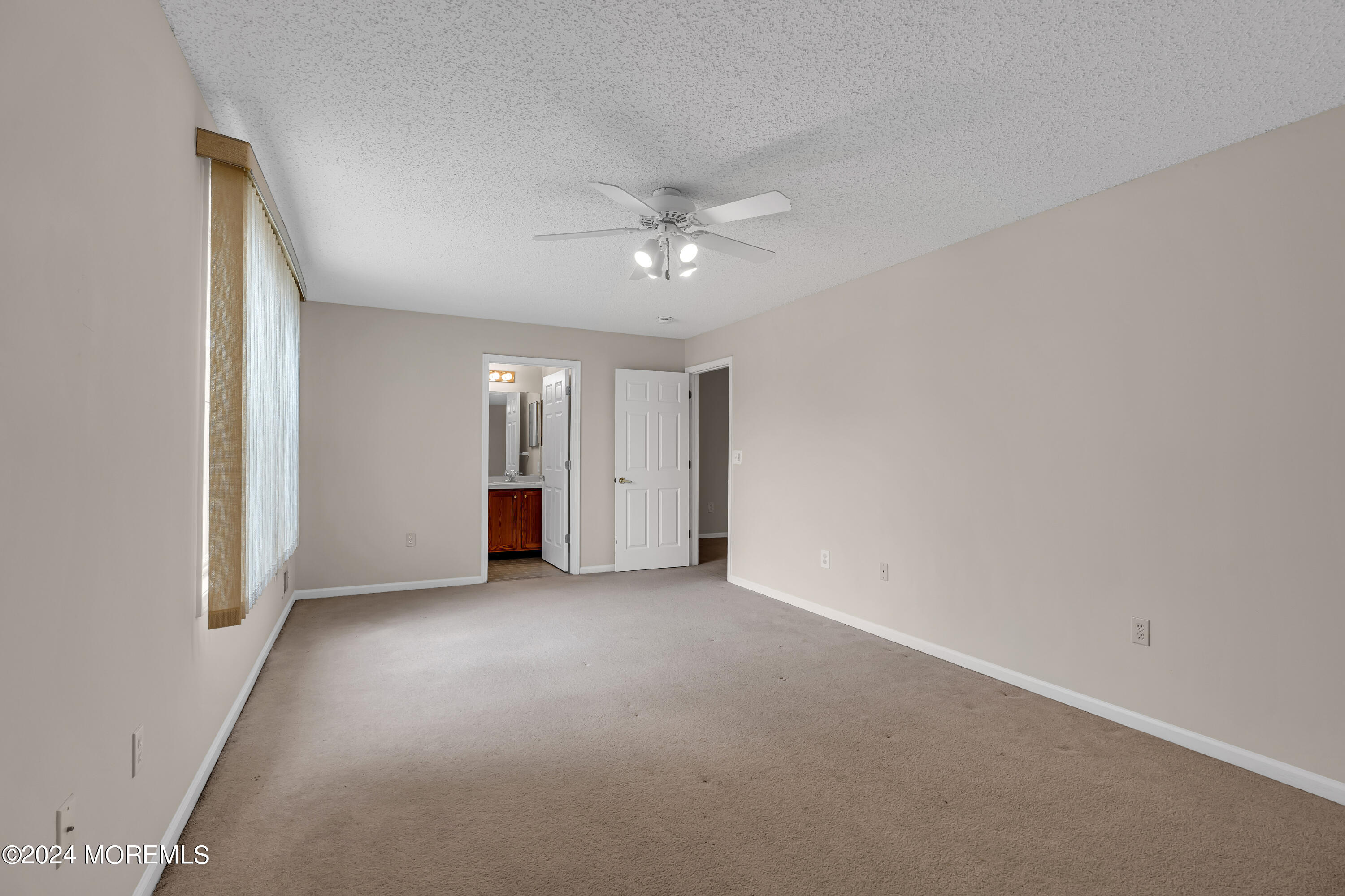 12 Riva Boulevard Brick, NJ 08723 - Photo 30 of 36 an empty room with a ceiling fan and a window